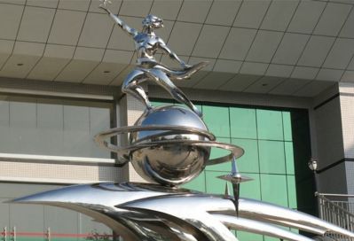广场摆放的踩球的不锈钢创意天天向上雕塑