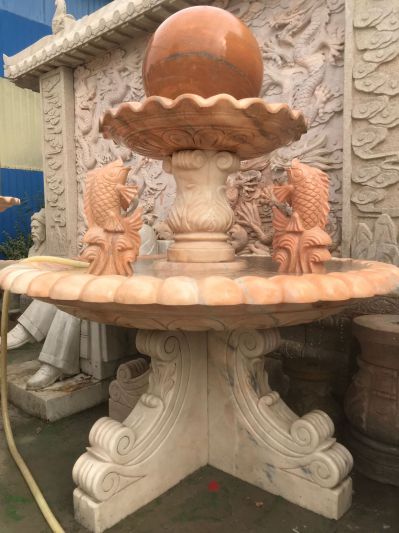 中式庭院晚霞红鲤鱼吐水石雕喷泉