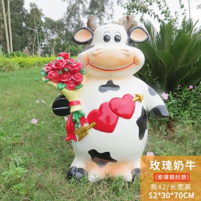 电影院一只拿玫瑰站立的玻璃钢牛雕塑