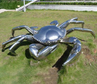 草地上摆放的不锈钢创意螃蟹雕塑