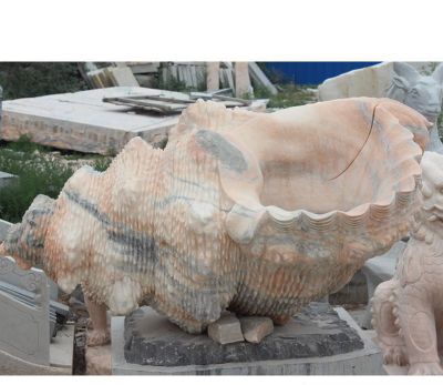 花池边摆放的花岗岩石雕创意海螺雕塑
