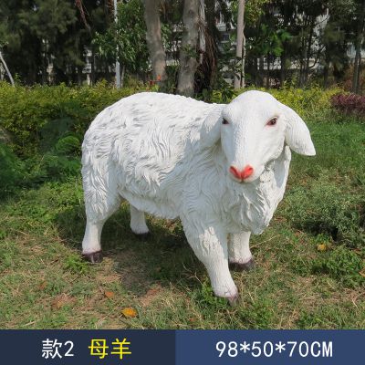 草地上摆放的一只耷拉着耳朵的玻璃钢仿真绵羊雕塑